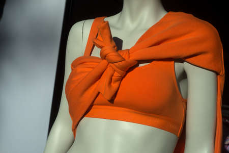 Mulhouse - France - 21 August 2022 - Closeup of orange bra by undiz on mannequin in fashion store...