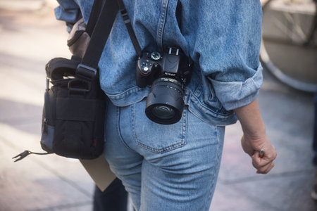 Strasbourg - France - 22 October 2022 - closeup of young woman with a canon camera standing in the streetのeditorial素材