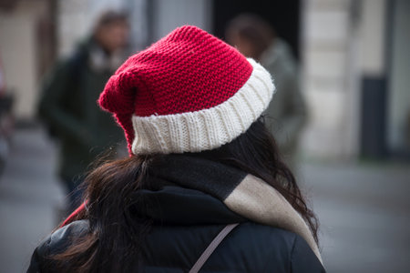 Portrait on back view of woman wearing a christmas hat in the streetの写真素材