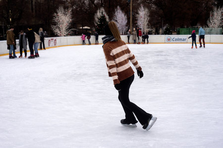 Colmar - France - 9 december 2022 - portrait of girl with black leggings slipping on an ice...