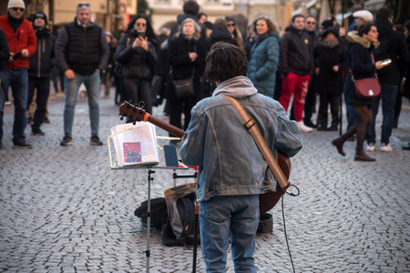 Strasbourg - France - 7 January 2022 - Portrait of musician playing guitar in the streetのeditorial素材