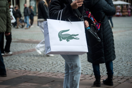 Strasbourg - France - 7 January 2022 - Closeup of woman with a Lacoste paper bag in the streetのeditorial素材