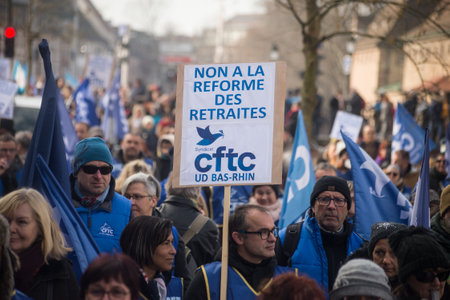 Strasbourg - France - 11 February 2023 - people protesting with placard in french : non a la reforme des retraites, in english , no to pension reformのeditorial素材