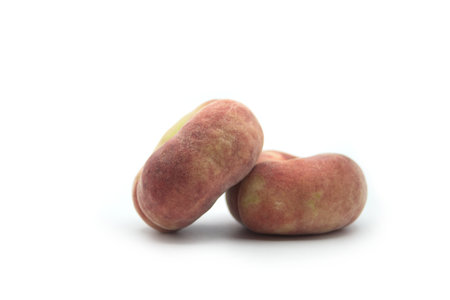 Closeup of flat peaches on white backgroundの写真素材