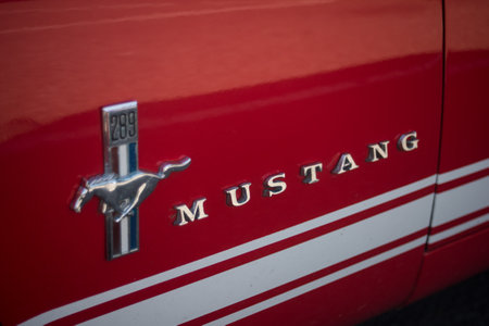 Mulhouse - France - 9 July 2023 - Closeup of logo on red ford mustang door parked in the street
