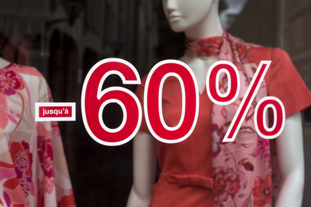 Closeup of 60 % sign on fashion store window on summer clothes backgroundの写真素材