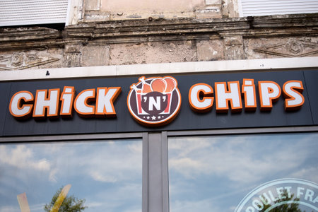 Mulhouse - France - 6 August 2023 - Closeup of chick 'n chips sign on fast food restaurant front in the streetのeditorial素材