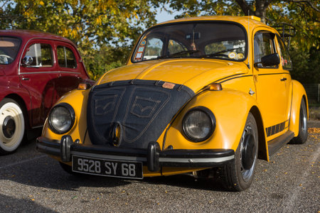 Mulhouse - France - 8 October 2023 - Front view of orange Volkswagen beetle car parked in the streetのeditorial素材