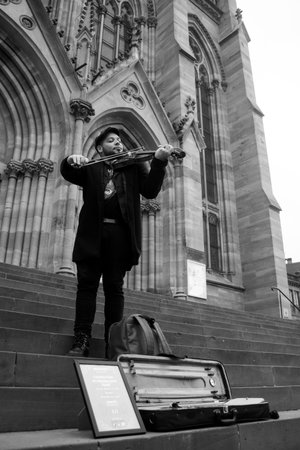 Mulhouse - France - 16 February 2024 - Portrait of street artist playing violin in the  streetのeditorial素材