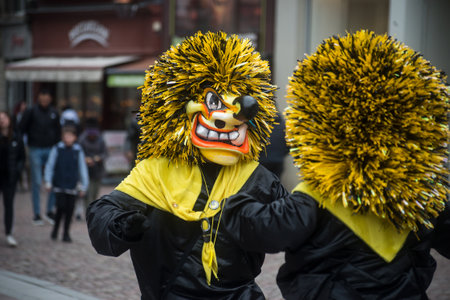 Mulhouse - France - 17 february 2024 - Two masked people dancing in the streetのeditorial素材