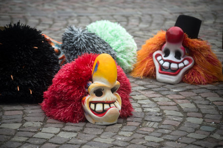 Mulhouse - France - 17 february 2024 - Closeup of traditional carnival masks posing on the floor  before the carnivalのeditorial素材