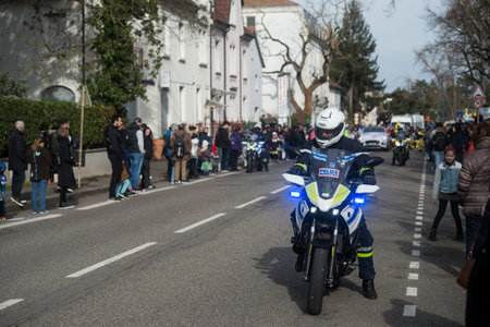 Mulhouse - France - 18 February 2024 - portrait of policeman on motorbike standing in the street before the carnivalのeditorial素材