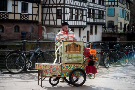 Strasbourg - France - 9 march 2024 -  Portrait of man playing with a barrel organ in the streetのeditorial素材