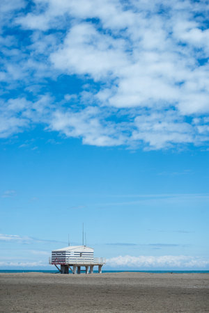 Gruissan - France - 27 April 2024 - view of wooden life guard station on the beach on beautiful cloudy sky backgroundのeditorial素材