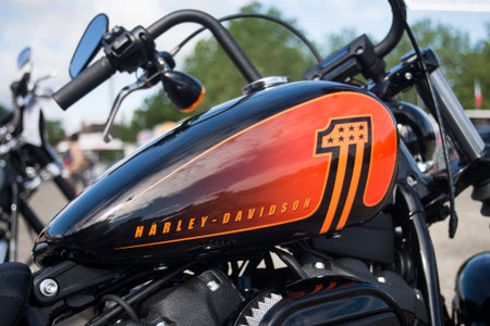 Illzach - France - 19 May 2024 - closeup od harley davidson orange tank on chopper motorbike parked...