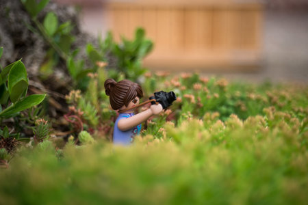 Mulhouse - France - 31 May 2024 - portrait of photographer playmobil standing in a public gardenのeditorial素材