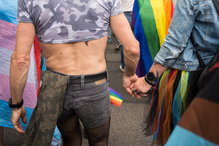 Mulhouse - France - 1 june 2024 - portrait on back view of people parading in the street with rainbow flagsのeditorial素材