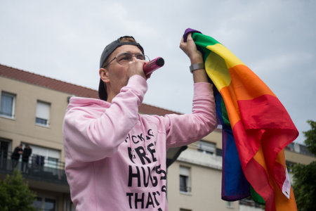 Mulhouse - France - 1 june 2024 - portrait of man speaking on microphone with a rainbow flag in handのeditorial素材
