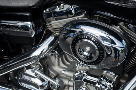 Mulhouse - France - 9 June 2024 - Closeup of Harley Davidson engine on black motorbike parked in the streetのeditorial素材