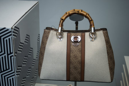 Mulhouse - France - 9 June 2024 - closeup of brown guess hand bag in a luxury fashion tote showroomのeditorial素材