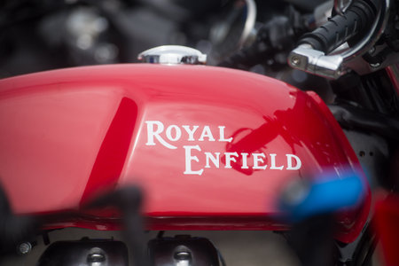 Mulhouse - France - 9 June 2024 - closeup of red tank of vintage royal enfield motorbike parked in...