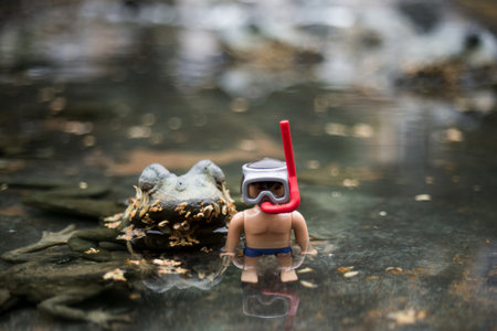 Mulhouse - France - 30 June 2024 - closeup of beach playmobil standing in a fountain with frogs
