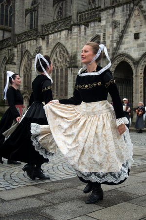 Quimper - France - 14 July 2024 - portrait of women dancing with a traditional costumes in the streetのeditorial素材