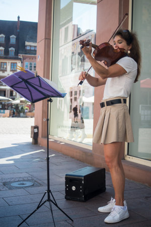 Mulhouse - France - 11 August 2024 -  Portrait of musician playing violin in the street