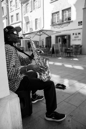 Mulhouse - France - 29 August 2024 - portrait of african musician playing saxophone in the street