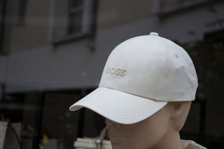 Mulhouse - France - 8 September 2024 - Closeup of beige Hugo Boss baseball cap on mannequin in a fashion store showroomのeditorial素材