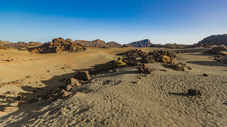 Mountain Teide with white snow spots, partly covered by the clouds. Bright blue sky. Teide National Park, Tenerife, Canary Islands, Spain.の写真素材
