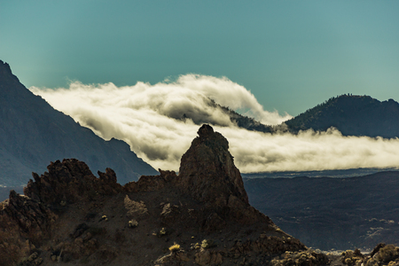 Mountain Teide with white snow spots, partly covered by the clouds. Bright blue sky. Teide National Park, Tenerife, Canary Islands, Spain.の写真素材