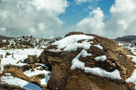 Mountain Teide with white snow spots, partly covered by the clouds. Bright blue sky. Teide National Park, Tenerife, Canary Islands, Spain.の写真素材