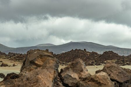 Mountains and lava fields around volcano Teide. Huge lava rockm sunset time. Teide National Park, Tenerife, Canary Islands, Spainの写真素材
