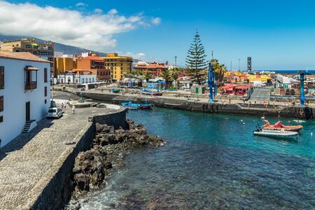 Puerto de la Cruz, Tenerife, Spain - July 10, 2019: . The Old port of town is a popular tourist attraction and favorite place for the locals. We see the harbor and mountains in the surrounding area.のeditorial素材