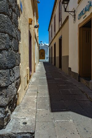 Puerto de la Cruz, Tenerife, Spain - July 10, 2019: Colourful houses and palm trees on streets. People relax and have fun on a warm sunny summer day. Have breakfast, drink coffee in a cozy cafe.のeditorial素材