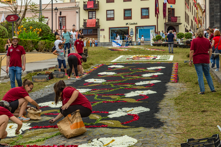 la Orotava, Tenerife, Spain - June 27, 2019. Beautiful flower carpets in La Orotava during Corpus Christi. Famous religious event and competition of folk art.. Warm summer evening and joyful visitors.のeditorial素材