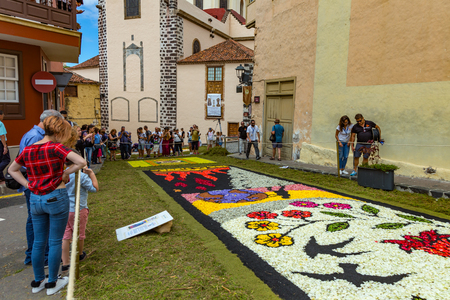 la Orotava, Tenerife, Spain - June 27, 2019. Beautiful flower carpets in La Orotava during Corpus Christi. Famous religious event and competition of folk art.. Warm summer evening and joyful visitors.のeditorial素材