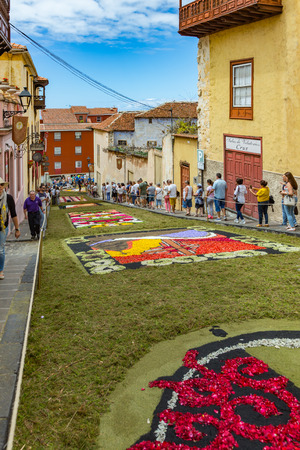 la Orotava, Tenerife, Spain - June 27, 2019. Beautiful flower carpets in La Orotava during Corpus Christi. Famous religious event and competition of folk art.. Warm summer evening and joyful visitors.のeditorial素材