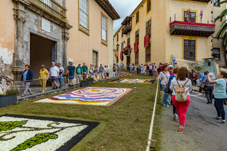 la Orotava, Tenerife, Spain - June 27, 2019. Beautiful flower carpets in La Orotava during Corpus Christi. Famous religious event and competition of folk art.. Warm summer evening and joyful visitors.のeditorial素材