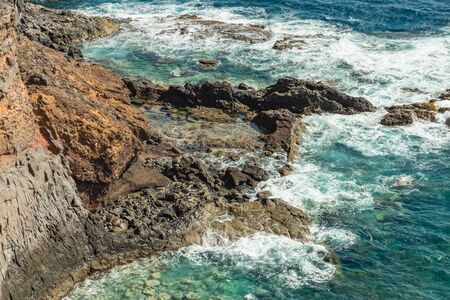 View from Punta de Faro, Telephoto lens. Lighthouse San Cristobal on Punta del Faro, located on a...