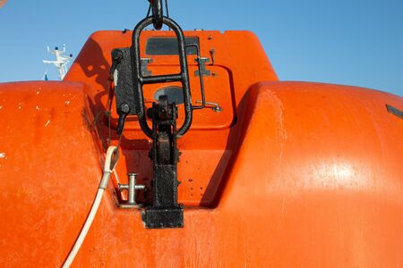 Metal staples mounting of orange life rescue boat rescue orange boat for emergency at sea, maritime...