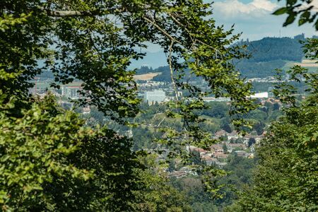 Bern, Switzerland - July 30, 2019: Panoramic view at sunny summer day fro the top of Gurten Mountain Park. Telephoto lens shot.の写真素材