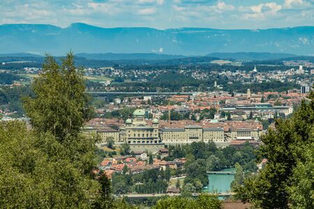 Bern, Switzerland - July 30, 2019: Panoramic view at sunny summer day fro the top of Gurten Mountain Park. Telephoto lens shot.の写真素材