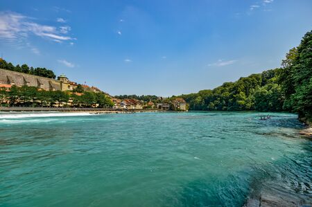 Bern, Switzerland - July 26, 2019: Panoramic view at sunny summer day. Aare river near Schwellenmatteli sport complex city Park.の写真素材