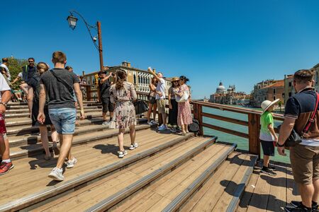 VENICE, ITALY - August 03, 2019: One of the thousands of lovely cozy corners in Venice on a clear sunny day. Locals and tourists strolling along the streets and historical buildings.のeditorial素材
