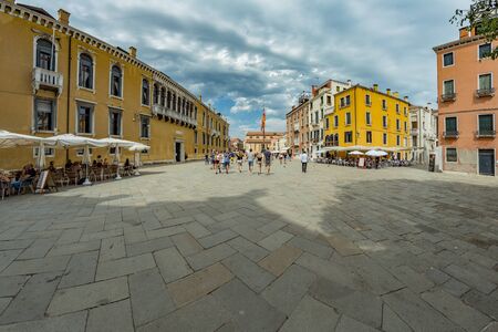 VENICE, ITALY - August 02, 2019: One of the thousands of lovely cozy corners in Venice on a clear sunny day. Locals and tourists strolling along the streets and historical buildings.のeditorial素材