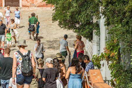 VENICE, ITALY - August 02, 2019: One of the thousands of lovely cozy corners in Venice on a clear sunny day. Locals and tourists strolling along the streets and historical buildings.のeditorial素材