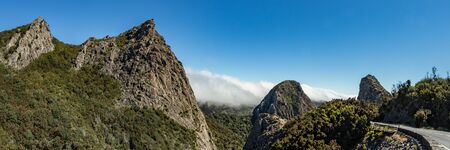 Panoramic view of The Rocks - Los Roques in La Gomera. A volcanic plug, also called a volcanic neck or lava neck, is a volcanic object created when magma hardens within a vent on an active volcanoの写真素材