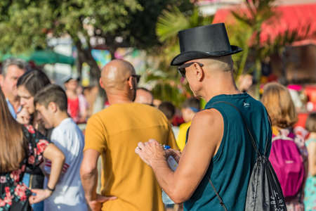 SANTA CRUZ DE TENERIFE, SPAIN - FEBRUARY 25, 2020: Around the Coso parade - along the Avenida de Anaga, official end of Carnival. Amazing warm evening, joyful people in carnival costumes have fun.のeditorial素材
